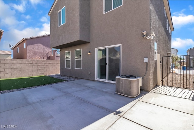 back of house with a patio area and cooling unit