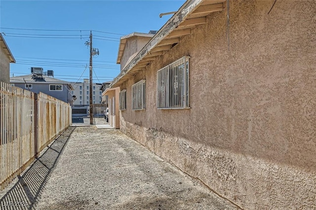 529 Mckellar Cir, Las Vegas, NV 89119 - view of side of home featuring stucco siding and fence