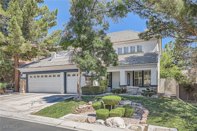 view of front property featuring a front lawn and a garage