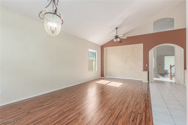 unfurnished living room featuring ceiling fan, light hardwood / wood-style floors, and high vaulted ceiling