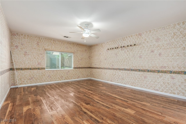 empty room featuring ceiling fan and hardwood / wood-style flooring