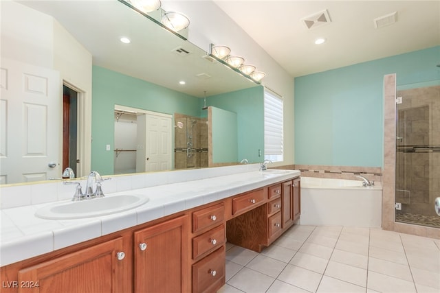 bathroom featuring tile patterned floors, vanity, and independent shower and bath