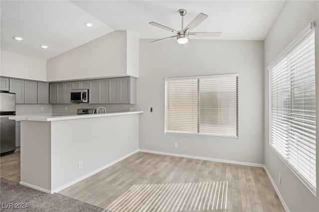 4811 Black Bear Rd Unit 201, Las Vegas, NV 89149 - kitchen featuring stainless steel appliances, gray cabinets, ceiling fan, light countertops, and high vaulted ceiling