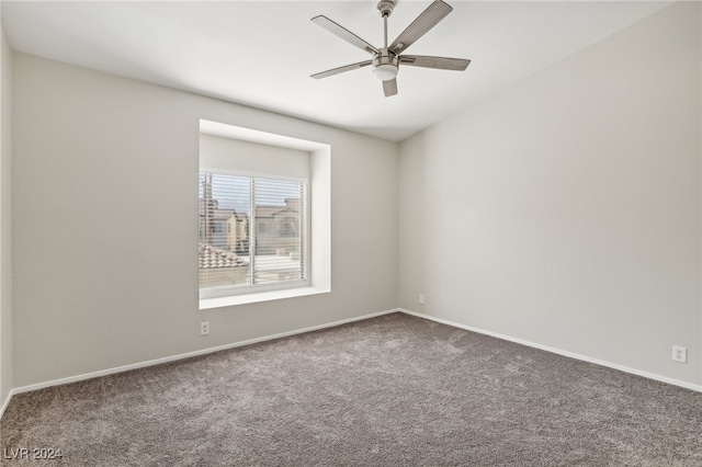 spare room with carpet floors and ceiling fan