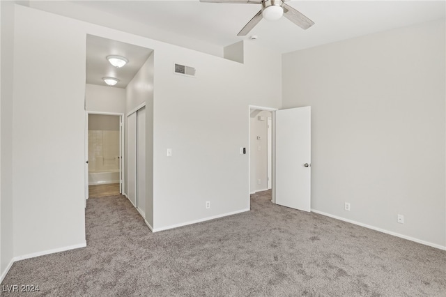 unfurnished bedroom featuring a closet, ceiling fan, and light carpet