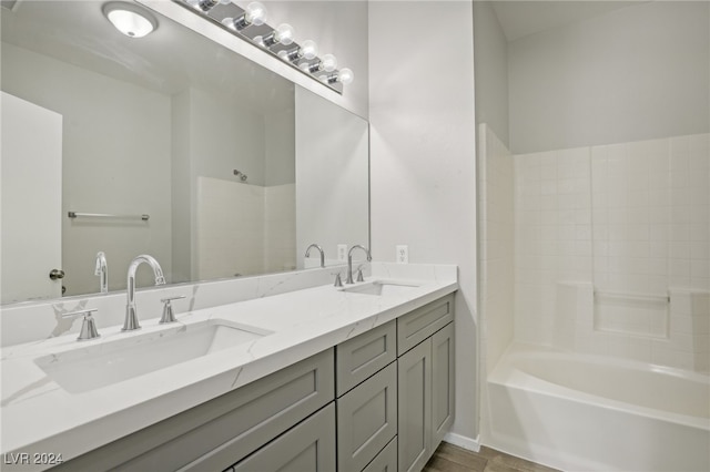 bathroom featuring vanity, shower / washtub combination, and hardwood / wood-style floors