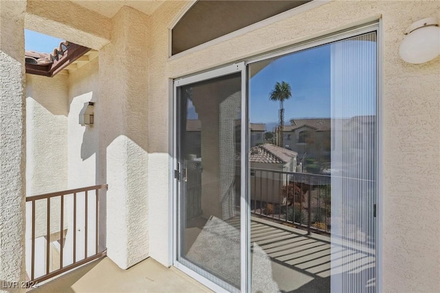 4811 Black Bear Rd Unit 201, Las Vegas, NV 89149 - doorway to property featuring stucco siding and a balcony