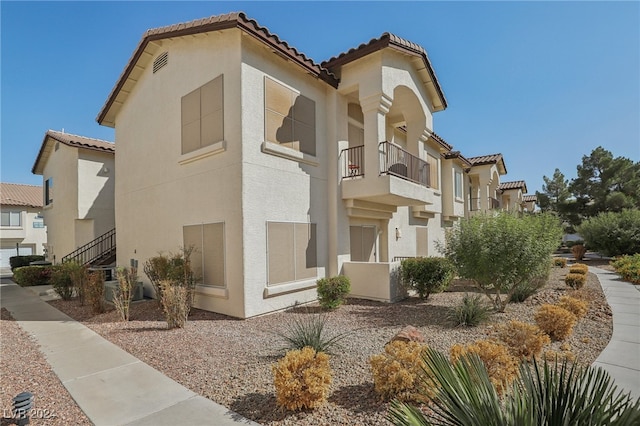 view of home's exterior featuring a balcony