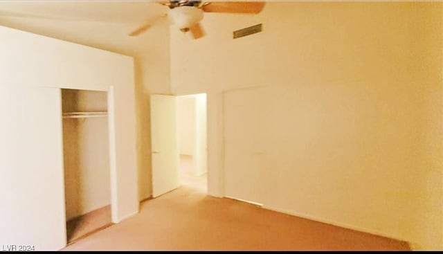 unfurnished bedroom with a closet, carpet, and ceiling fan