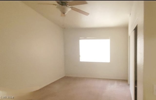 spare room with carpet flooring and ceiling fan