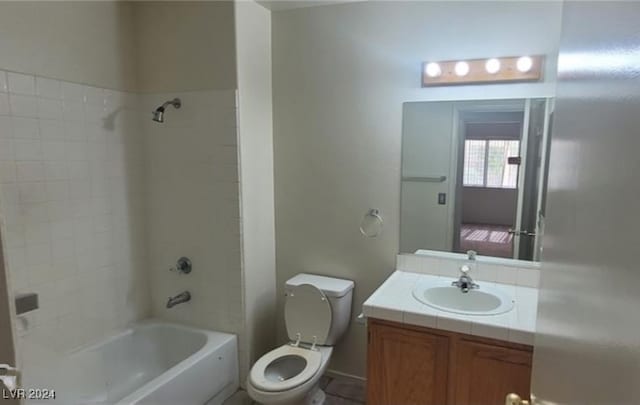 full bathroom featuring vanity, toilet, and tiled shower / bath