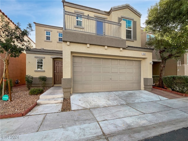 view of front of property with a garage and a balcony