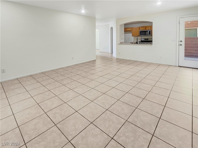 unfurnished living room with light tile patterned flooring