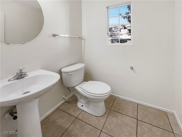 bathroom with toilet and tile patterned flooring