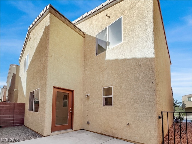 back of property with a patio area