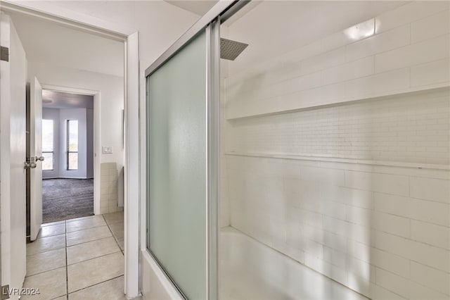 bathroom featuring shower / bath combination with glass door and tile patterned flooring