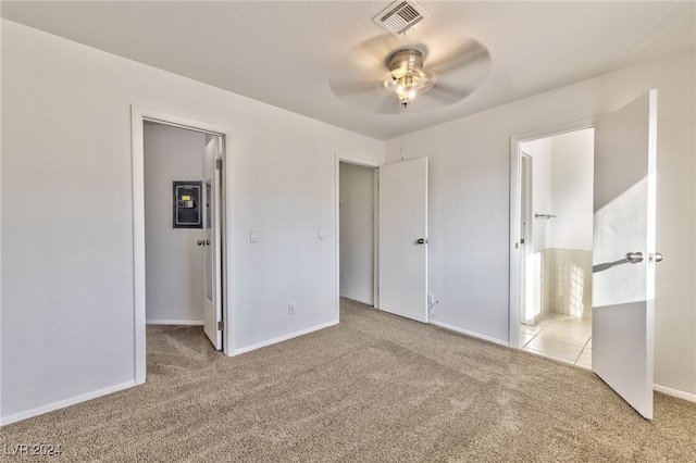 unfurnished bedroom featuring light colored carpet and ceiling fan