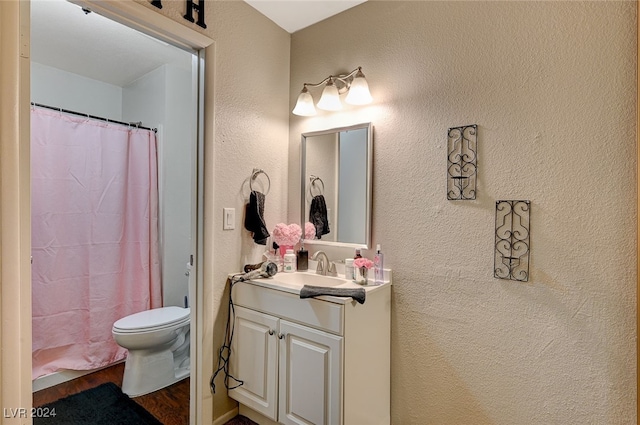 bathroom featuring vanity, hardwood / wood-style flooring, and toilet