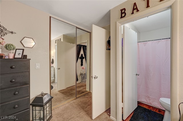 bathroom with toilet and curtained shower