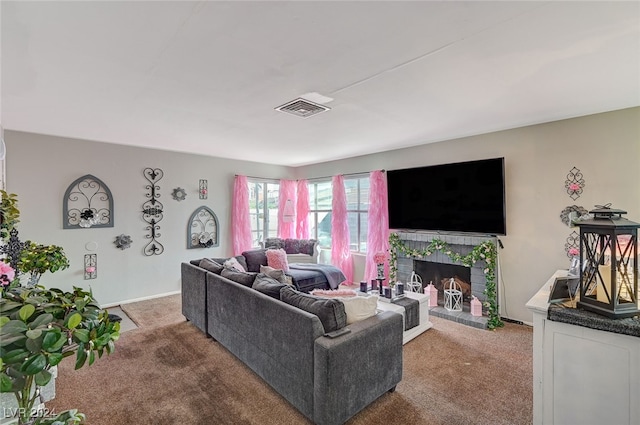 carpeted living room with a tile fireplace