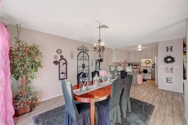 dining room featuring light hardwood / wood-style floors and an inviting chandelier