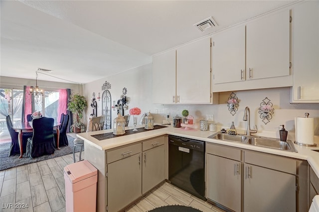 kitchen featuring kitchen peninsula, hanging light fixtures, light hardwood / wood-style flooring, dishwasher, and sink