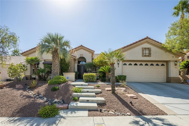 mediterranean / spanish-style home with a garage