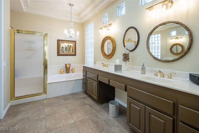 bathroom featuring a chandelier, tile patterned floors, a tray ceiling, and separate shower and tub