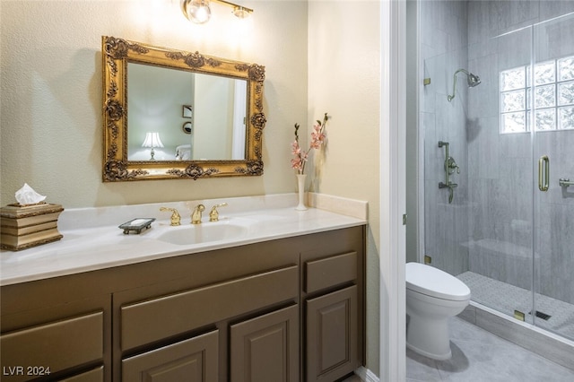 bathroom featuring tile patterned floors, vanity, an enclosed shower, and toilet