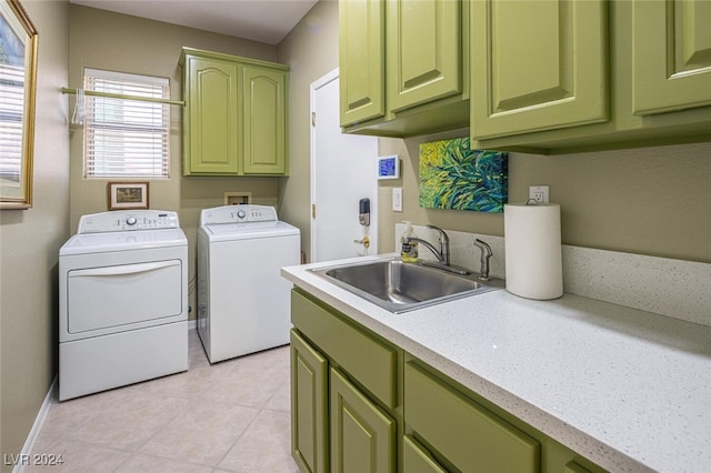 clothes washing area featuring cabinets, independent washer and dryer, sink, and light tile patterned floors