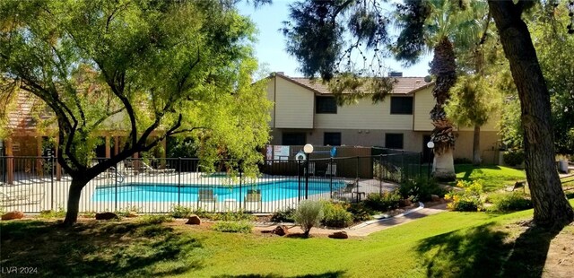 view of swimming pool with a yard and a patio