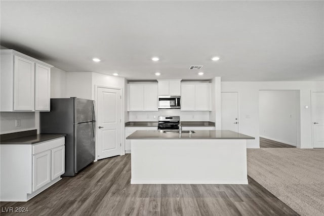 kitchen featuring white cabinets, stainless steel appliances, and dark hardwood / wood-style flooring