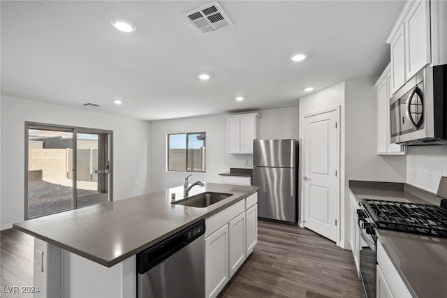 kitchen featuring sink, dark hardwood / wood-style flooring, stainless steel appliances, white cabinets, and a kitchen island with sink