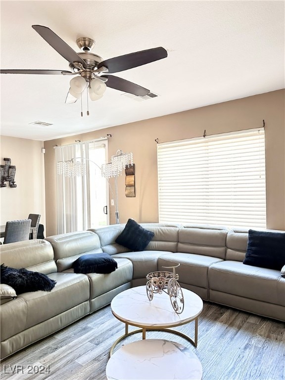 living room featuring ceiling fan and hardwood / wood-style flooring