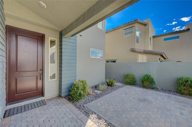 entrance to property with a patio