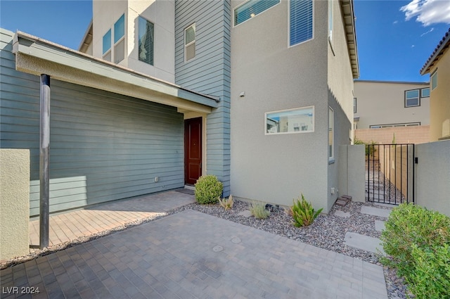 view of exterior entry featuring a patio area