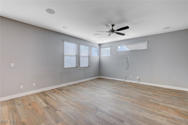 empty room featuring light hardwood / wood-style flooring and ceiling fan