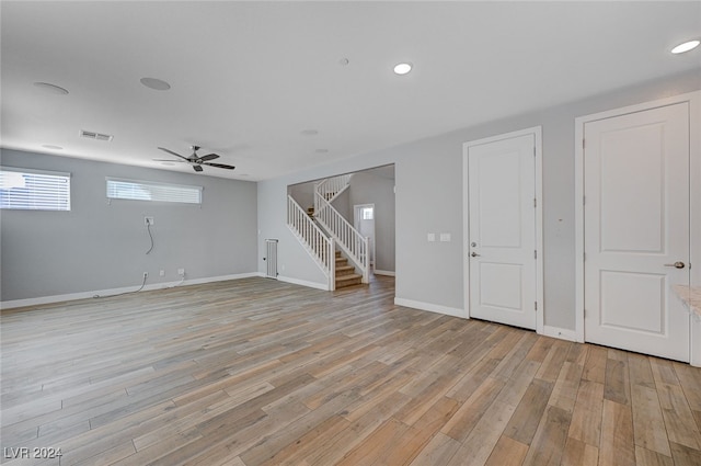 basement with light wood-type flooring and ceiling fan