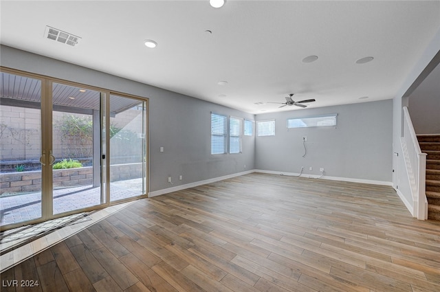 unfurnished living room with ceiling fan, a healthy amount of sunlight, and light wood-type flooring