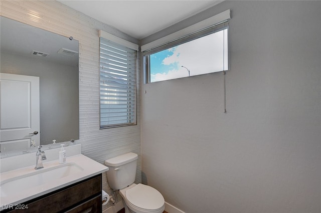 bathroom featuring toilet and vanity