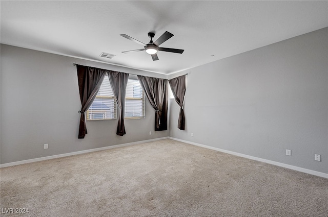 spare room featuring light carpet and ceiling fan