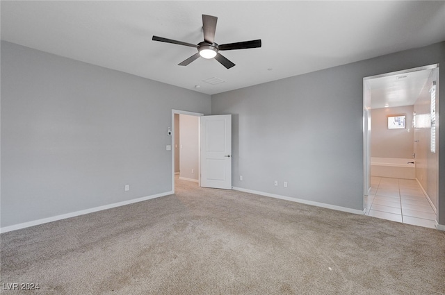 unfurnished bedroom featuring light colored carpet and ceiling fan