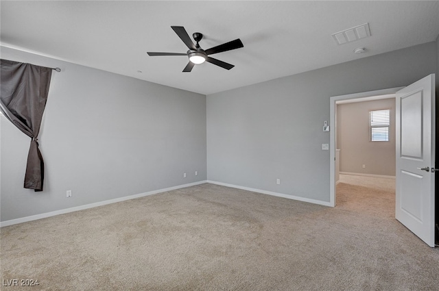 carpeted spare room with ceiling fan