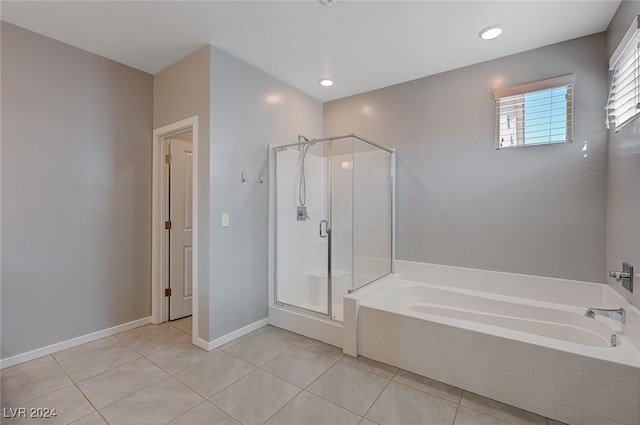 bathroom with independent shower and bath and tile patterned floors