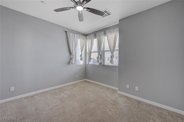 carpeted empty room featuring ceiling fan