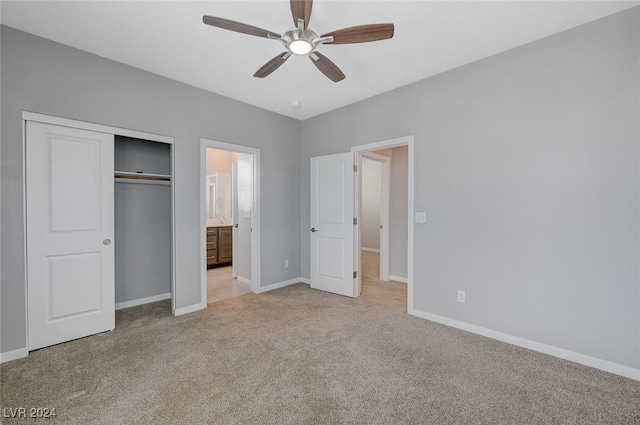 unfurnished bedroom featuring light colored carpet, a closet, and ceiling fan