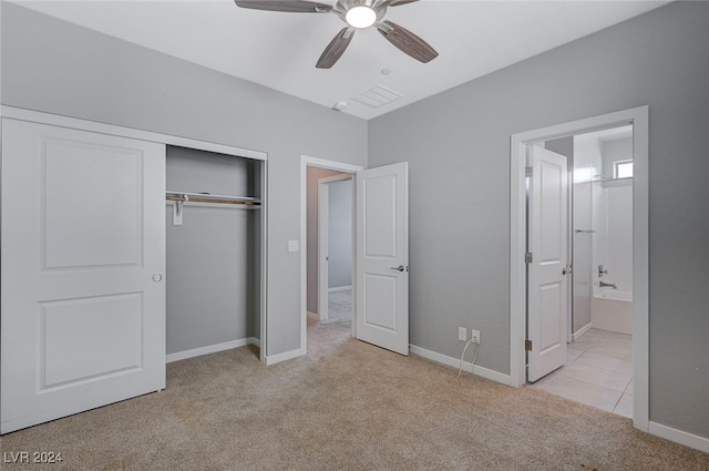 unfurnished bedroom with ceiling fan, ensuite bathroom, and light colored carpet