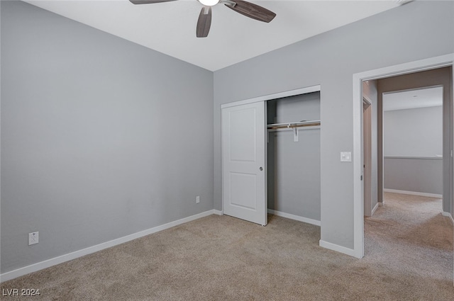 unfurnished bedroom featuring a closet, ceiling fan, and light colored carpet