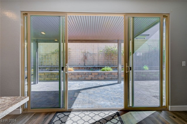 doorway to outside with a healthy amount of sunlight and hardwood / wood-style floors