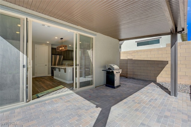 view of patio with grilling area and sink